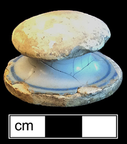 Tin glazed earthenware knobbed lid that has been shaped into a gaming piece - from 18CV91.